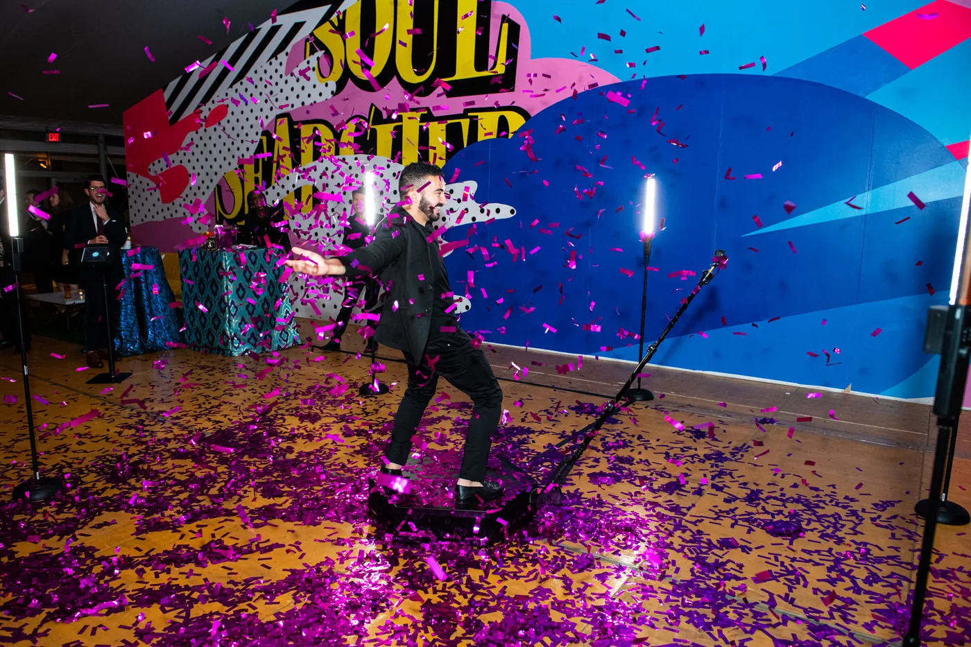 Guest on a 360 video booth platform with confetti in the air