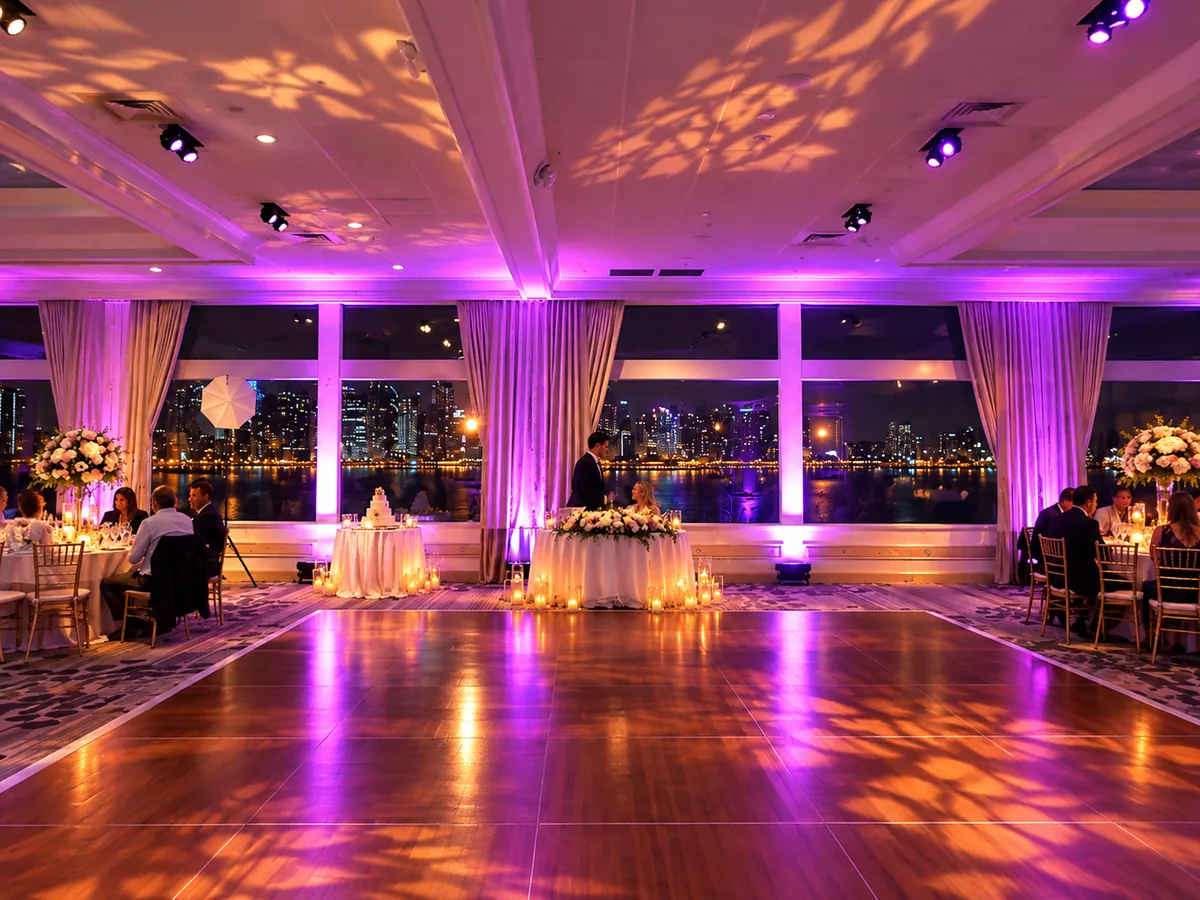 Dance floor lit with leaf patterns and purple uplighting, city skyline through the windows